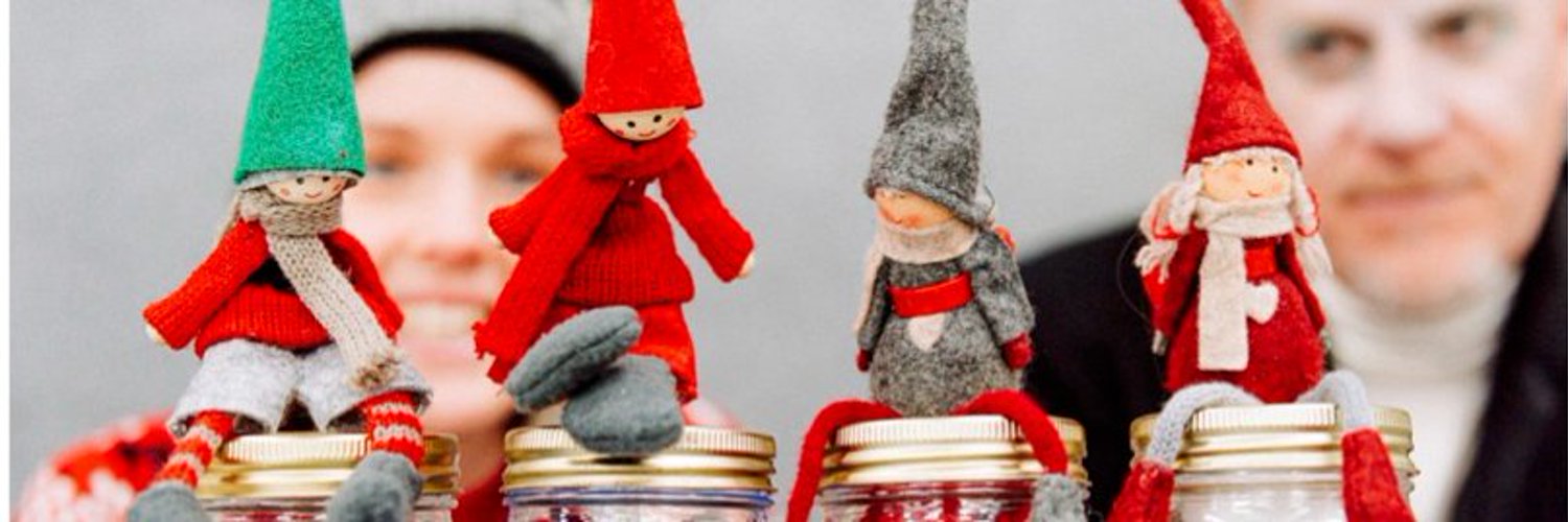 Two small puppets, both wearing felt clothing. One is red, the other is grey.